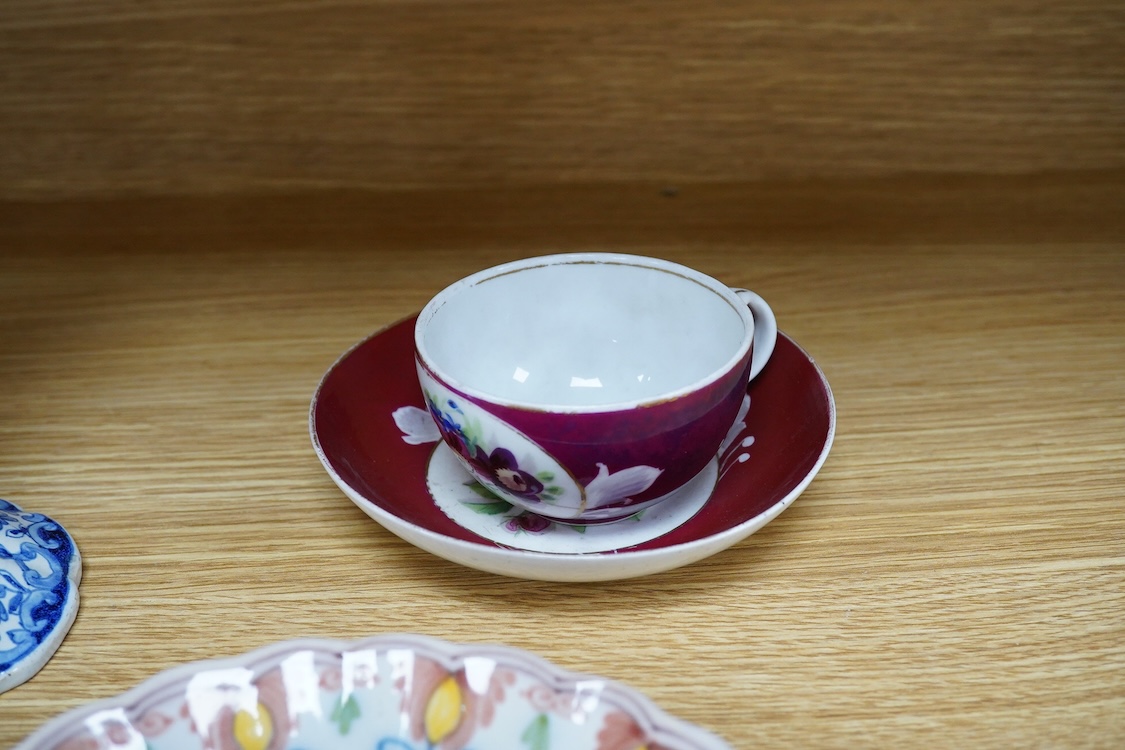 An 18th century Delft plate, two tin-glazed dishes and candlestick, a Gardener Russian porcelain tea cup and saucer, and a mug with liner, largest 22cm in diameter